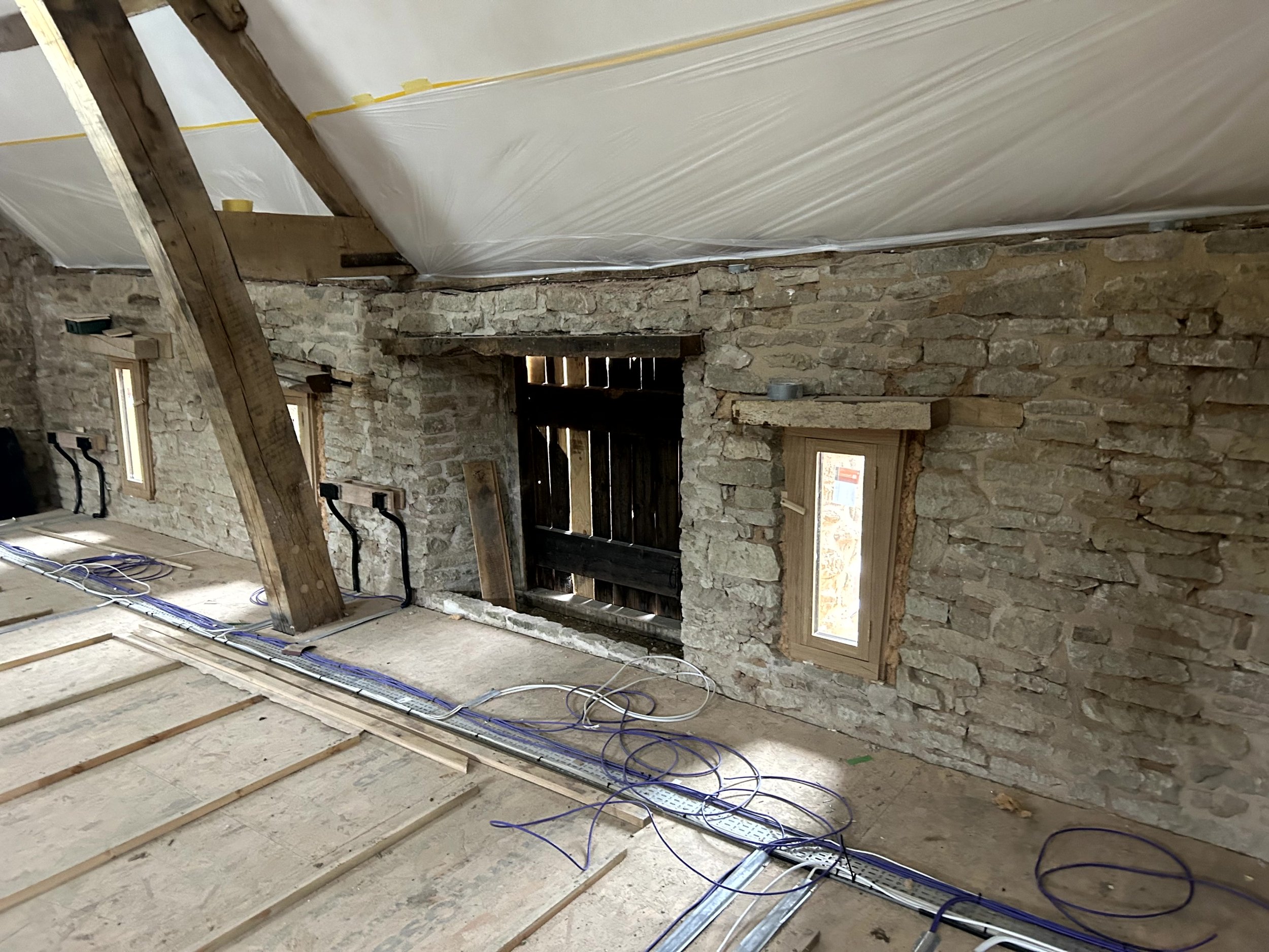 Bare stone wall either side of an old timber door reveal, before hempcrete installation